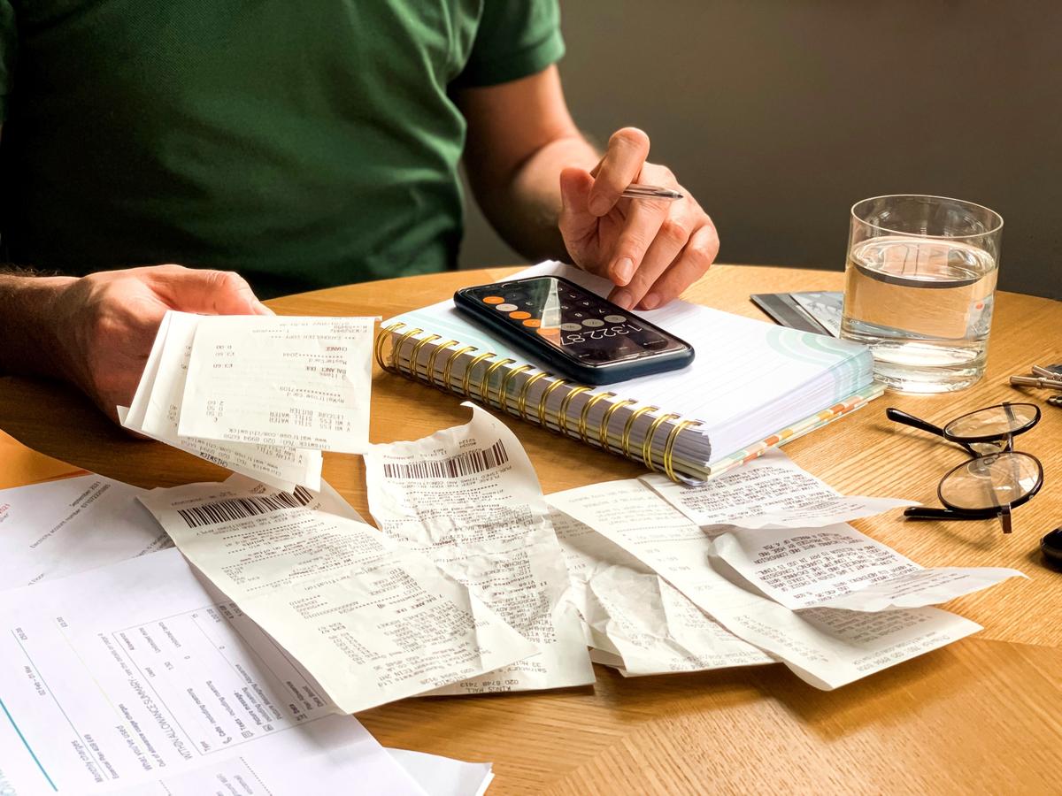 Woman focused on her laptop reviewing her finances at home.
