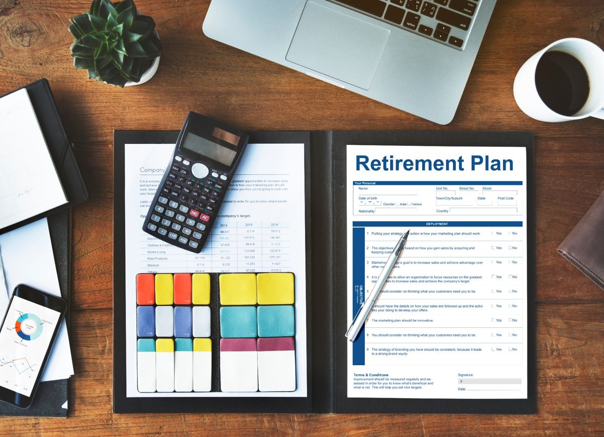 Older couple reviewing their finances together on a tablet at home.