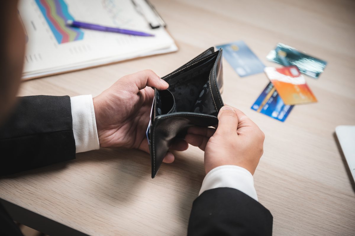 Advisor discussing debt options with a client across a desk